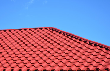 New red metal tiled roof house roofing construction exterior.