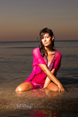 Fototapeta na wymiar young beautiful woman with long hair on the beach