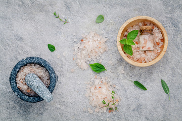 Himalayan pink salt in wooden bowl with peppermint ,sage,thyme,b