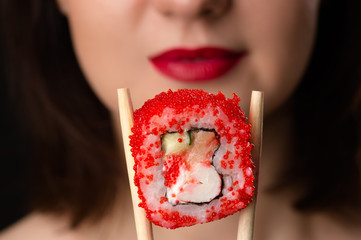girl holding roll chopsticks