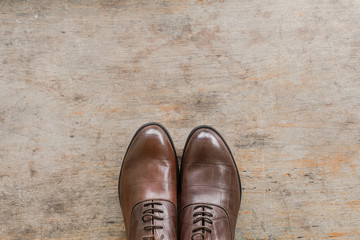 classic brown leather men's shoes on wooden background, Vintage tone filter