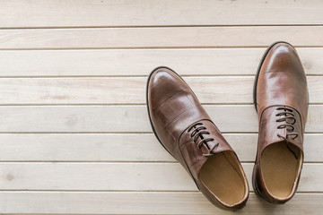 classic brown leather men's shoes on wooden background, Vintage tone filter