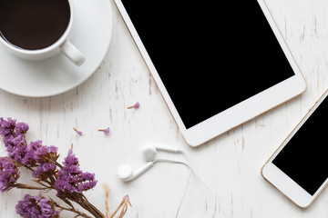 Black coffee with smartphone and tablet on white rustic wooden background