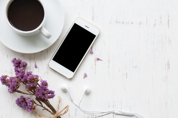 Black coffee with smartphone on white rustic wooden background