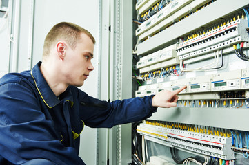 electrician engineer inspector in front of fuseboard
