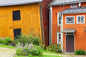 Fototapeta na wymiar Yellow wooden houses along the street, Porvoo