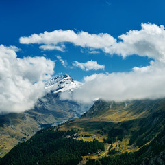 Naklejka na ściany i meble Snow capped alpine mountains. Trek near Matterhorn mount.