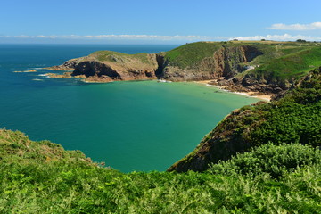 Plemont Bay, Jersey, U.K.  Popular tourist destination in the Summer with a high tide.