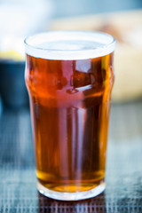 Pint of Bitter Beer in a Glass on a Table Setting