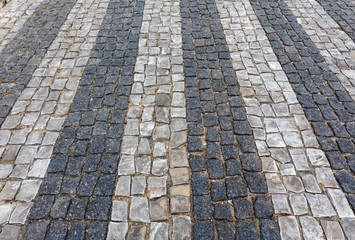 Cobbled road as background.