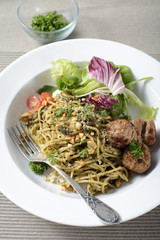Italian pasta spaghetti with pesto sauce and meatballs