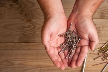 Workman holding nails