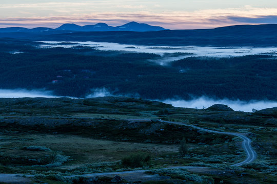 Sunrise in the Swedish mountains, very early during summertime. Morning mist down in the valley. © Ojvind