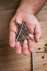 Workman holding nails