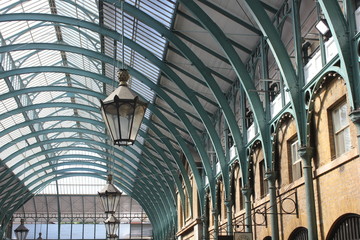 Architectural detail of Covent Garden glazed roof and a lamp, London