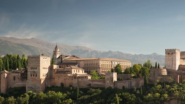 Time lapse of the alhambra palace in granada with the sierra nevada mountains in the distance