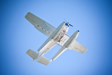 Sea Float Plane Flying Over - Blue Sky