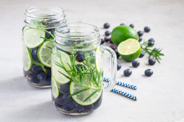 Healthy infused water with fresh blueberry, lime and rosemary, horizontal