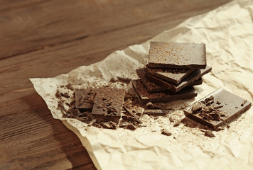 Chocolate pieces covered with cocoa powder on a paper