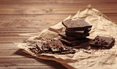 Chocolate pieces covered with cocoa powder on paper