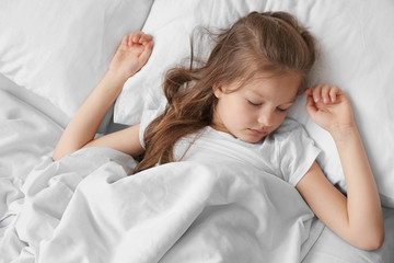 Fototapeta na wymiar Cute sleeping girl in white bed