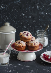 Delicious summer dessert - red currant muffins  on a dark background.  Rustic and vintage style