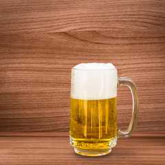 Glass of beer on wooden background