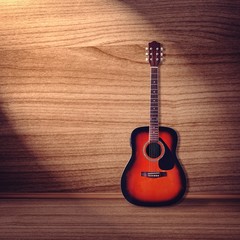 Classical guitar on wood background