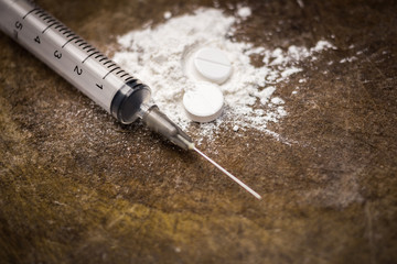 Syringe and heroin on wooden background with shadow edge. Drug a