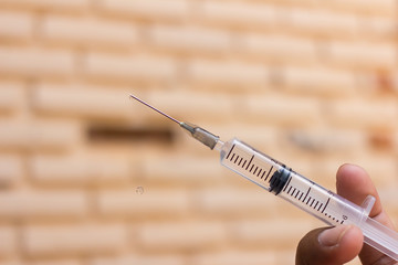 Syringe with needle on blur background