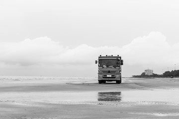Fototapeta premium Truck on the beach with black and white