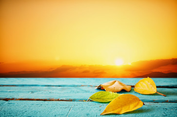 Autumn background with dry leaves on wooden table