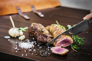 serving carving roast pork meat roll meal in rustic style