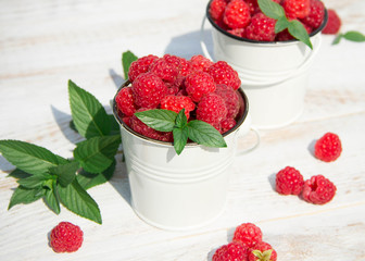 Sweet raspberries in bowl on wooden table. Close up, top view