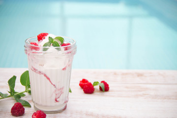 Ice cream with berries on wooden background