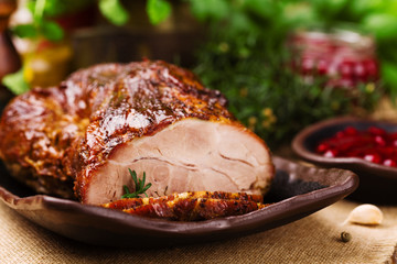 Roast pork with cranberry dip, basil, coriander and rosemary.