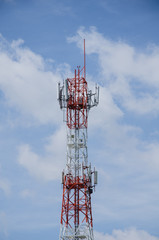 The communication tower,red & white color with rice field and beautiful sky.