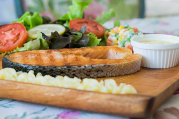 Grilled Salmon steak with salad.
