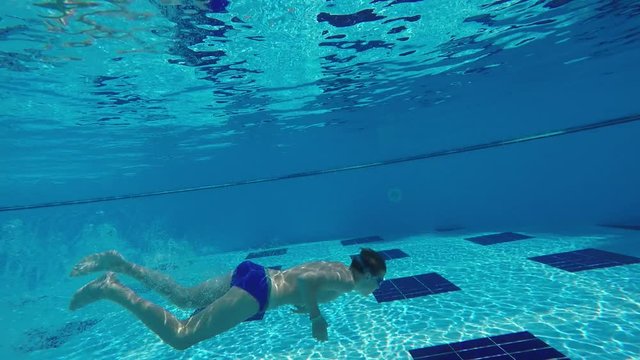 boy diving into a swimming pool