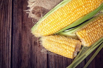 sweet corn on wooden background  © circleps