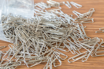 group of paper clips on wooden table background