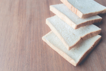 slice of bread on wooden table background