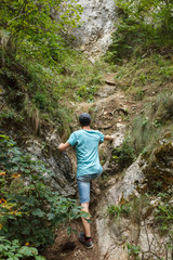 Teenager hiking on the steep trail