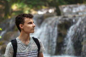 Hiker boy near a waterfall