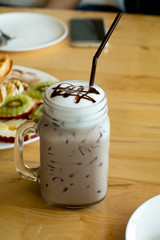 Glass of chocolate milkshake in mug vintage look