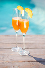 Bellini cocktail with peach isolated near pool
