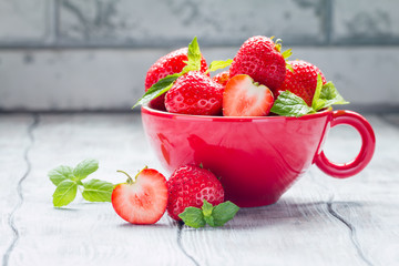 Fresh ripe strawberries in red bowl 