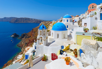 Oia town on Santorini island, Greece. Traditional and famous houses and churches with blue domes...