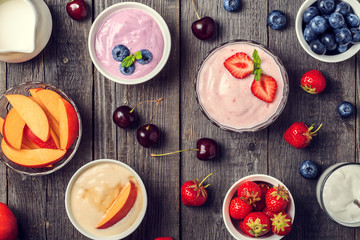 Fototapeta na wymiar Homemade yogurt with fresh strawberry, blueberry, peach on a woo