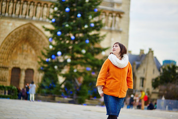 Happy young woman in Paris at Christmas